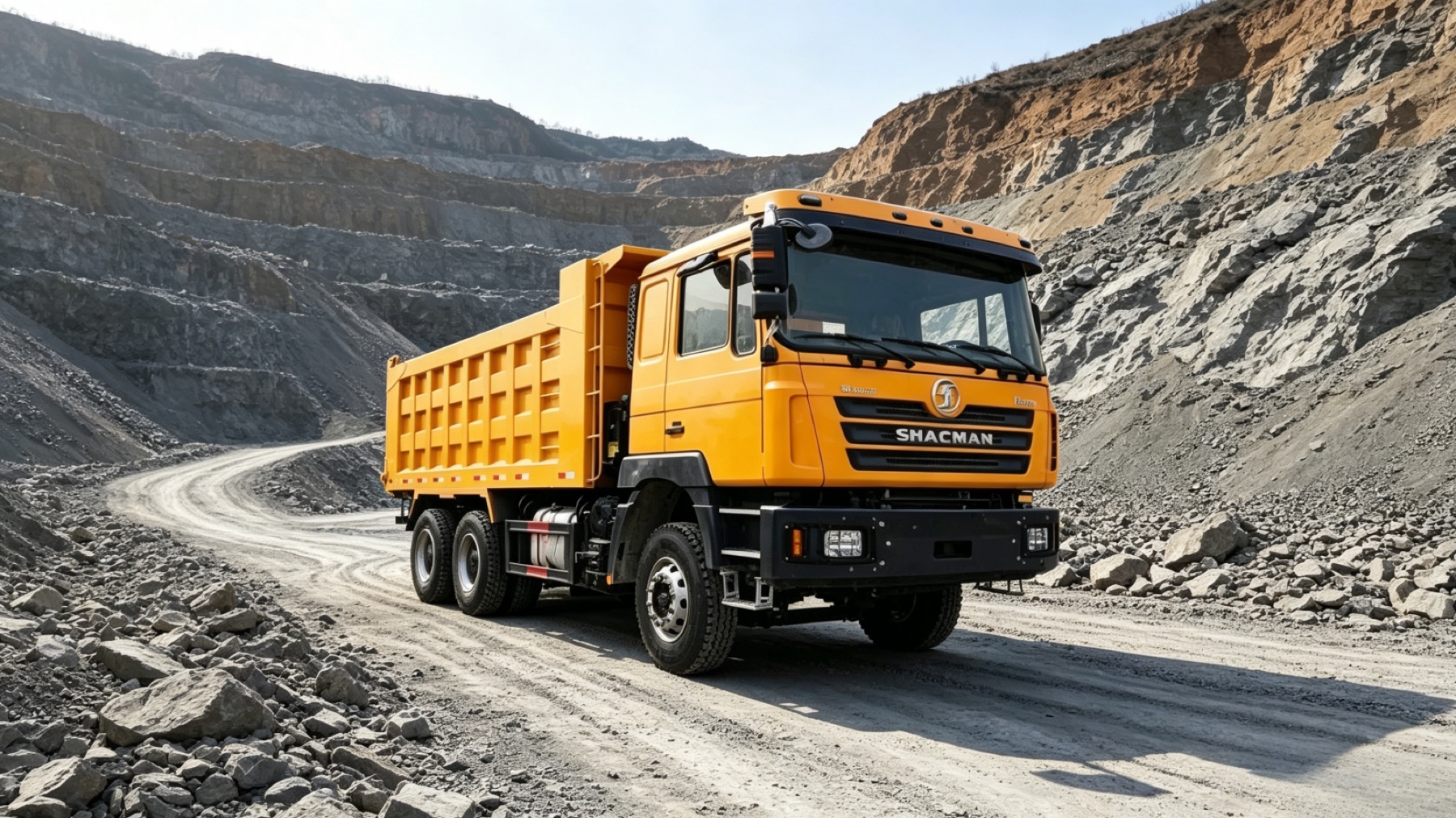 Orange SHACMAN dump truck operating in a quarry